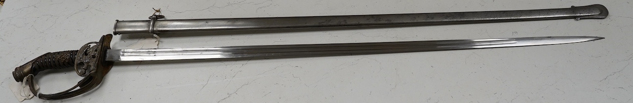 An 1889 Wilhelm II Prussian infantry officer’s sword with folding side guard, in a steel scabbard, blade 83.5cm. Condition - fair, worn overall